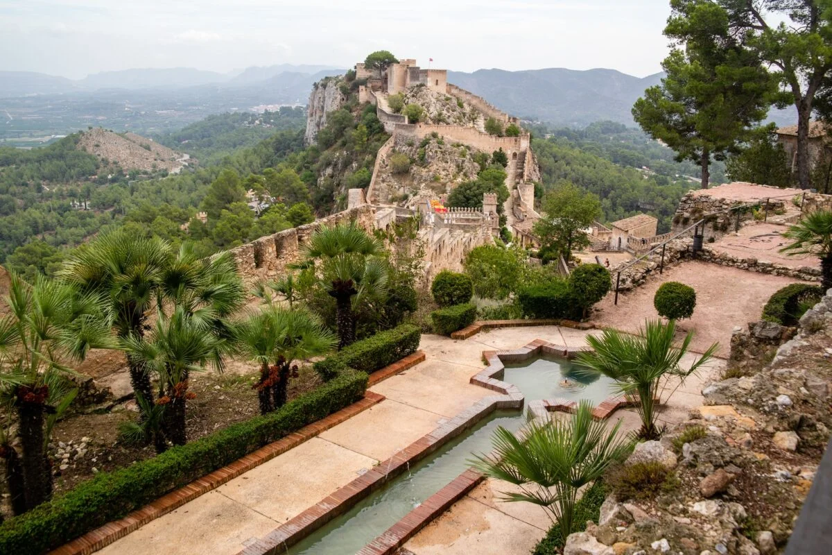 Beautiful shot of a historical monument Castillo de Jativa in Spain with water fountain