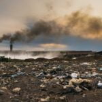 Garbage in front of Smokestack Factory, industry and pollution concept