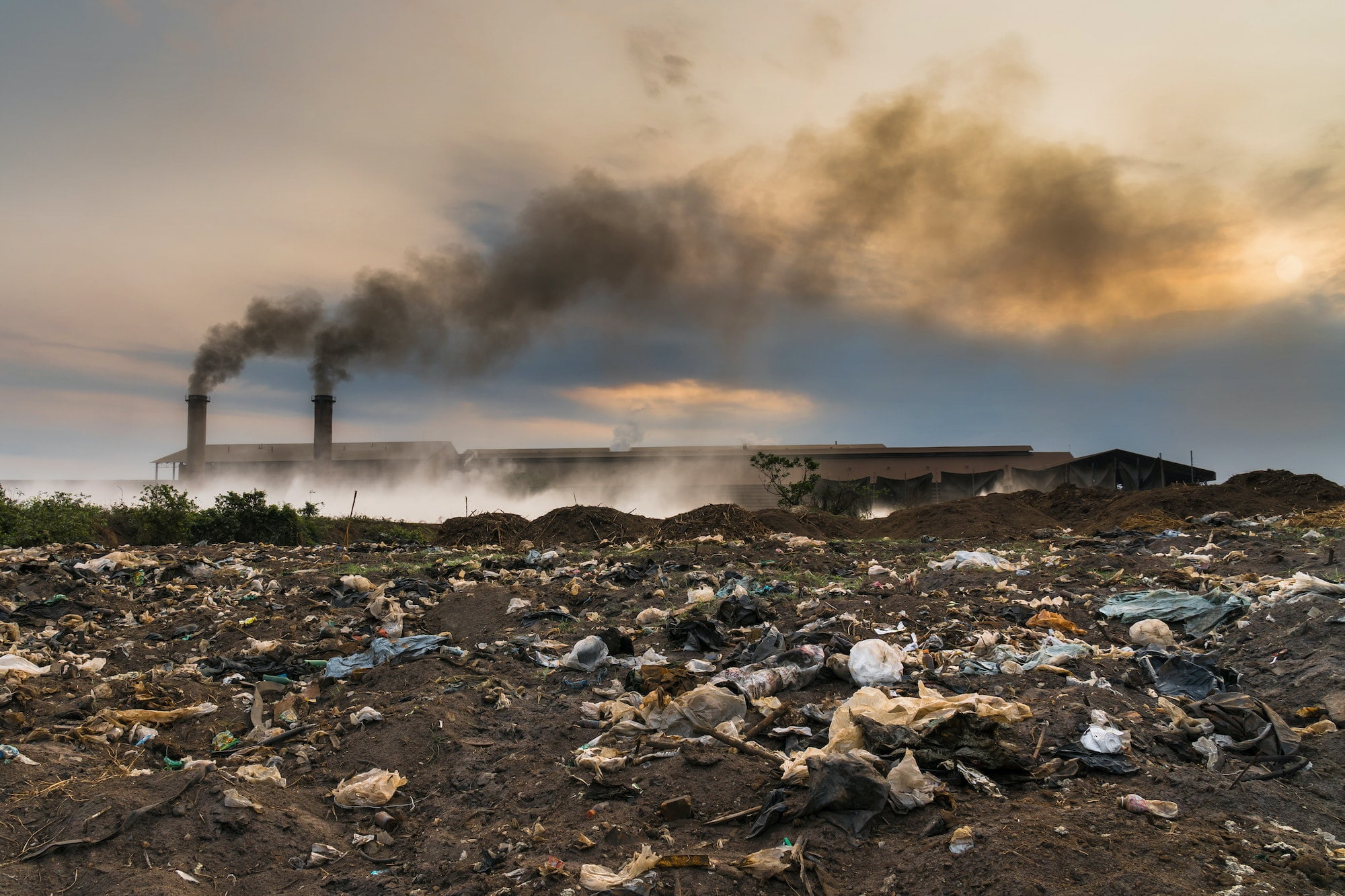 Garbage in front of Smokestack Factory, industry and pollution concept