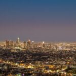 city skyline under blue sky during night time