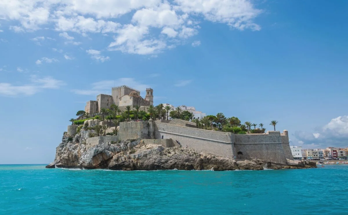 Peniscola Castle overlooking the Mediterranean Sea on blue white sky background in Spain