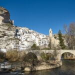 Picturesque white village and church. Alcala del Jucar. Spain