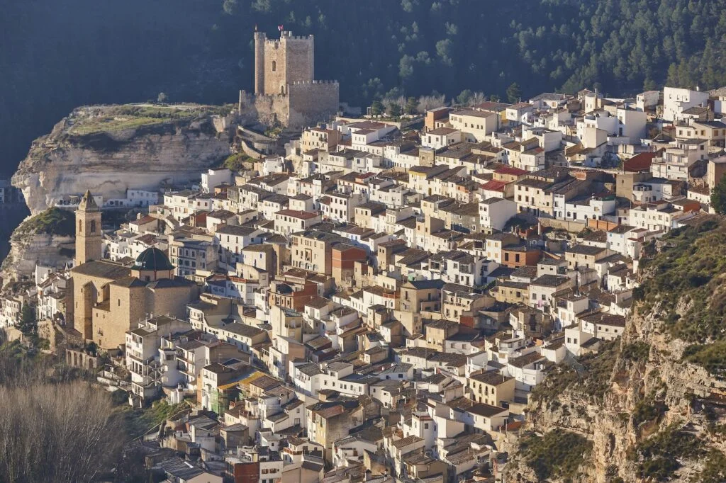 Picturesque white village on the mountain. Alcala del Jucar. Spain