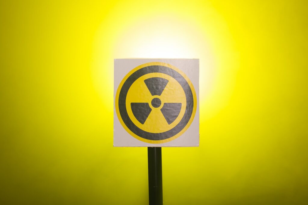 Radiation and danger concept - Radioactivity sign and the dramatic smokey background
